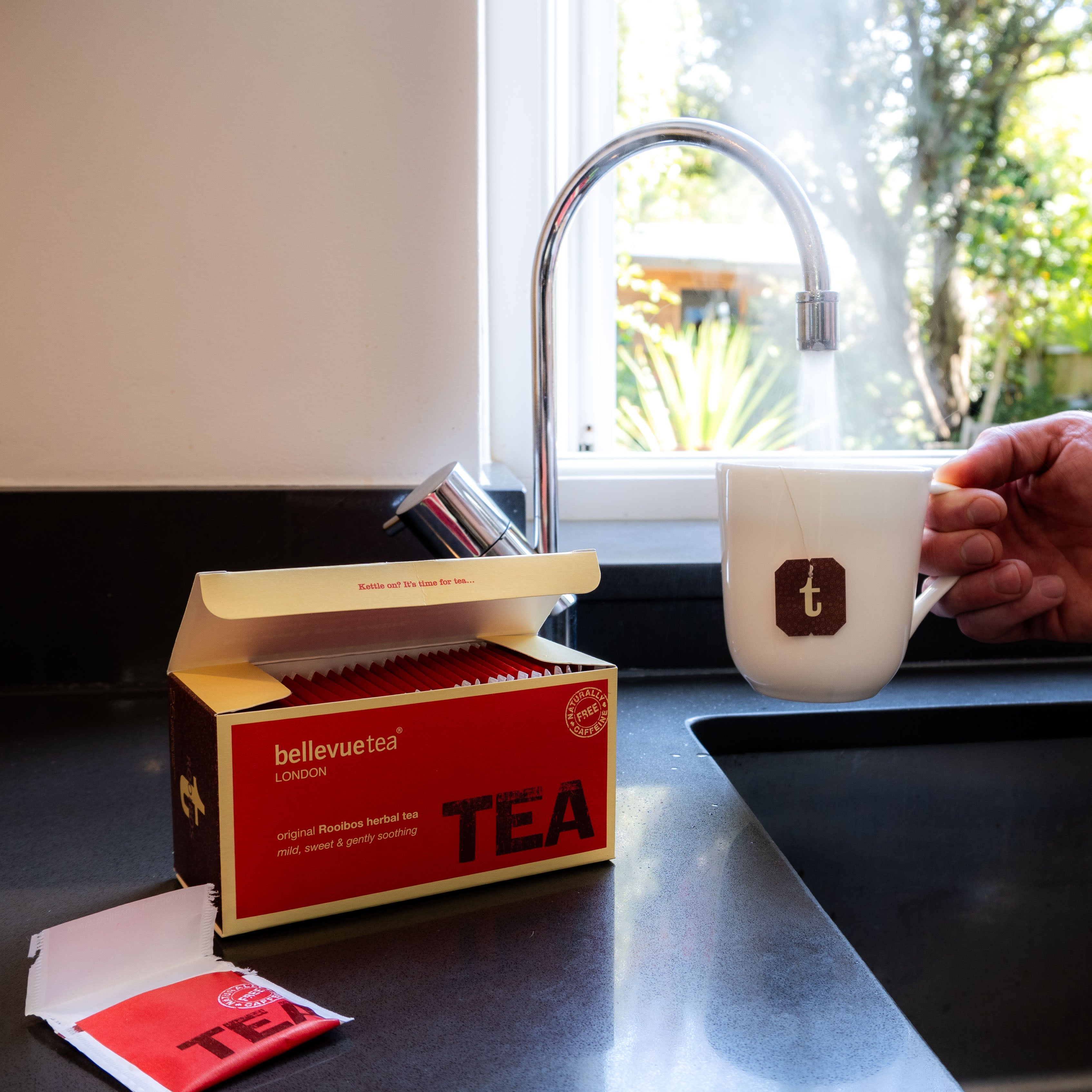 Cup of Bellevue Tea Rooibos Herbal Infusion Being Poured – Caffeine-Free South African Red Bush Tea