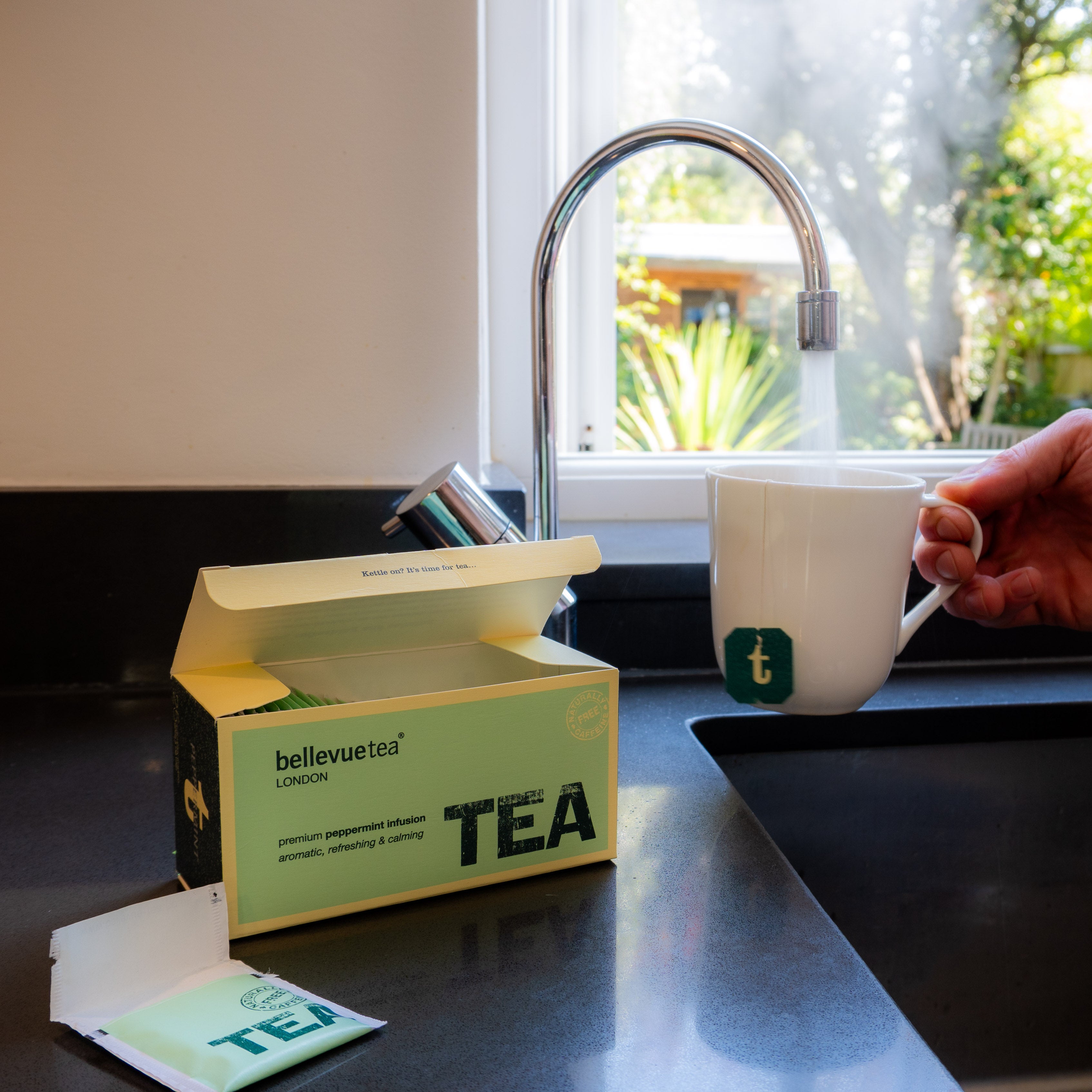 Cup of Bellevue Tea Peppermint Infusion Being Poured – Caffeine-Free Refreshing Herbal Tea