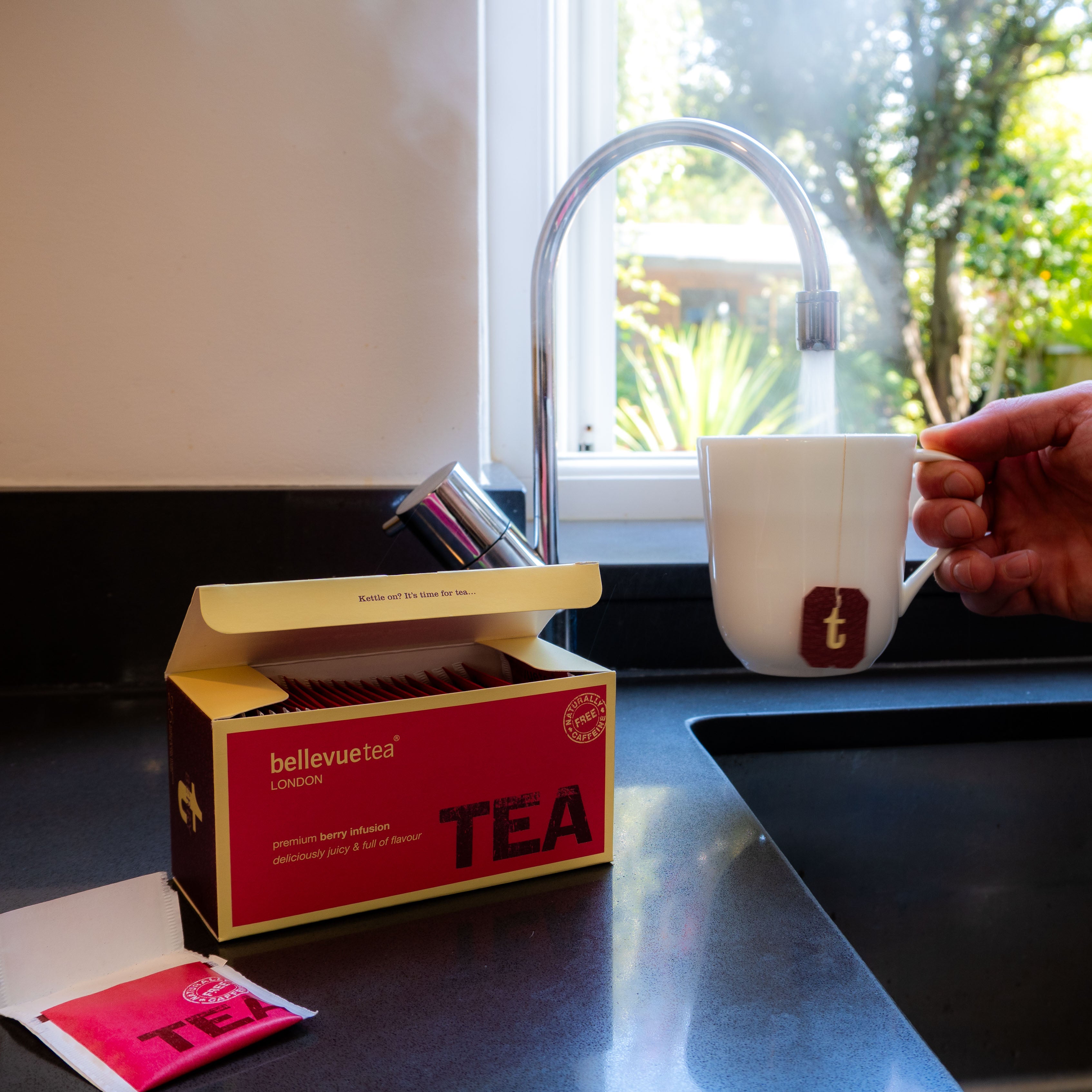 Cup of Bellevue Tea Berry Infusion Being Poured – Caffeine-Free Fruity Mixed Berry Herbal Tea